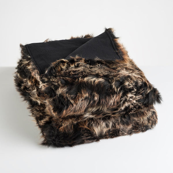 luxurious truffle brown sheep skin fur blanket with cashmere wool lining lying neatly folded