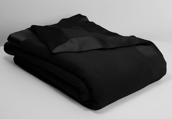 hollywood ava luxury cashmere and lambswool blanket in black lying neatly folded with an off white background
