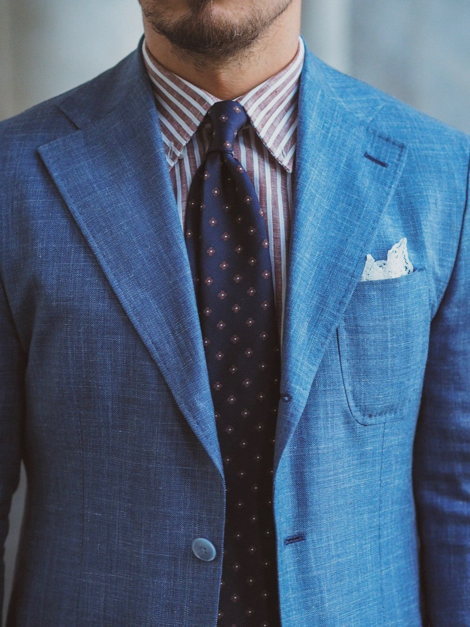 Light blue suit and striped shirt details