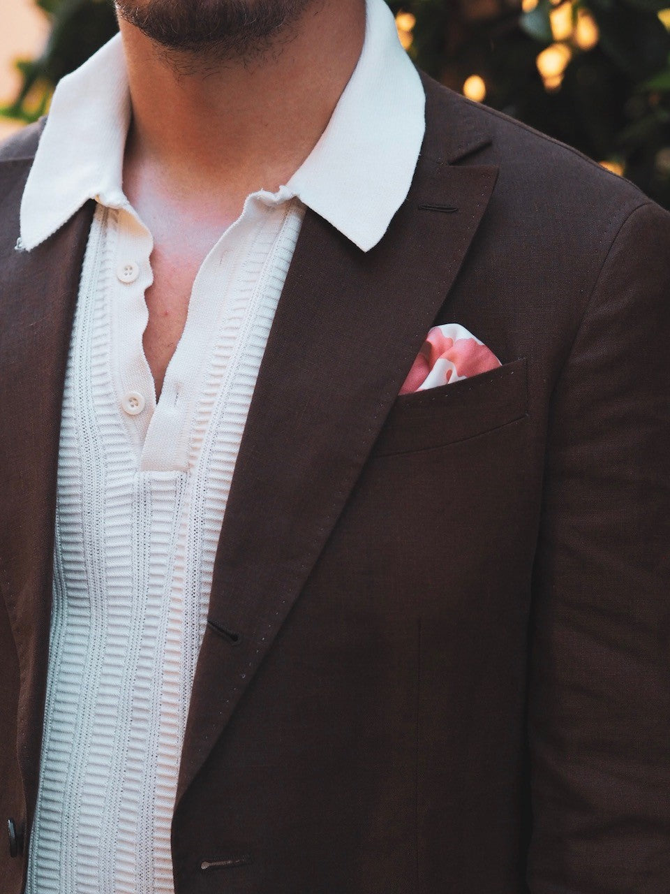 White knitted polo shirt with brown linen suit jacket details and textures