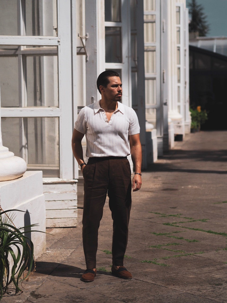 White knitted polo shirt with brown linen trousers