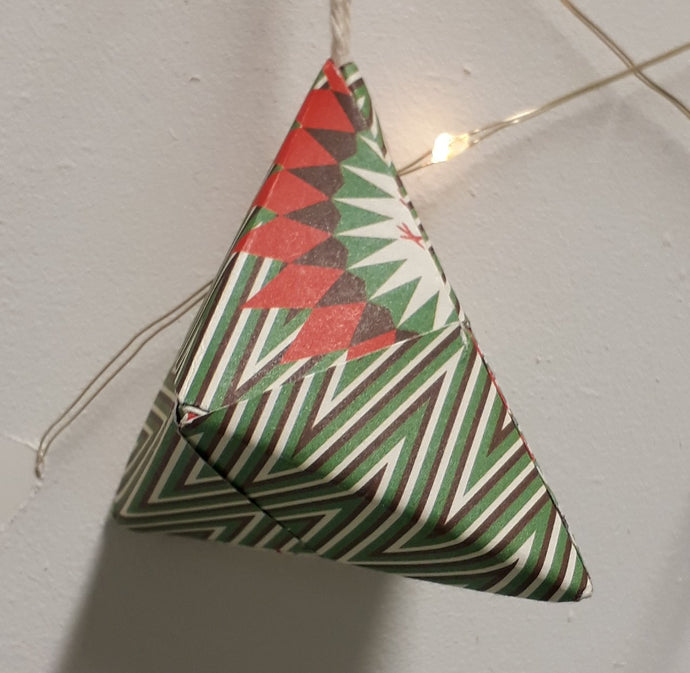 Small pyramid shaped green and white striped handmade origami Christmas bauble