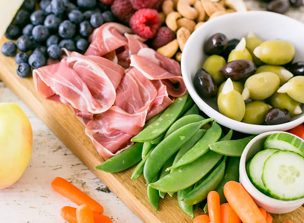 Easy Keto Snack: Charcuterie and Veggie spread on a wooden platter
