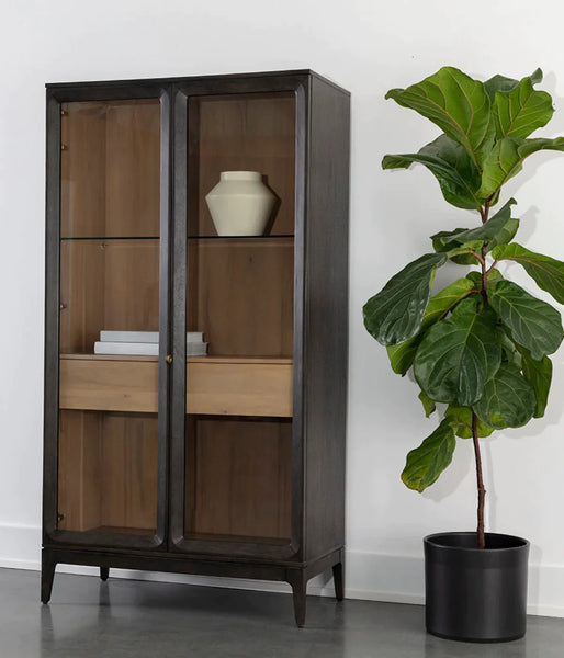 Simple and sophisticated, the Cecilia Display Cabinet features a mid-century design with understated details. Crafted with a smoked grey acacia veneer base and clear tempered glass doors. Solid rubberwood legs and brass handles finish the look.