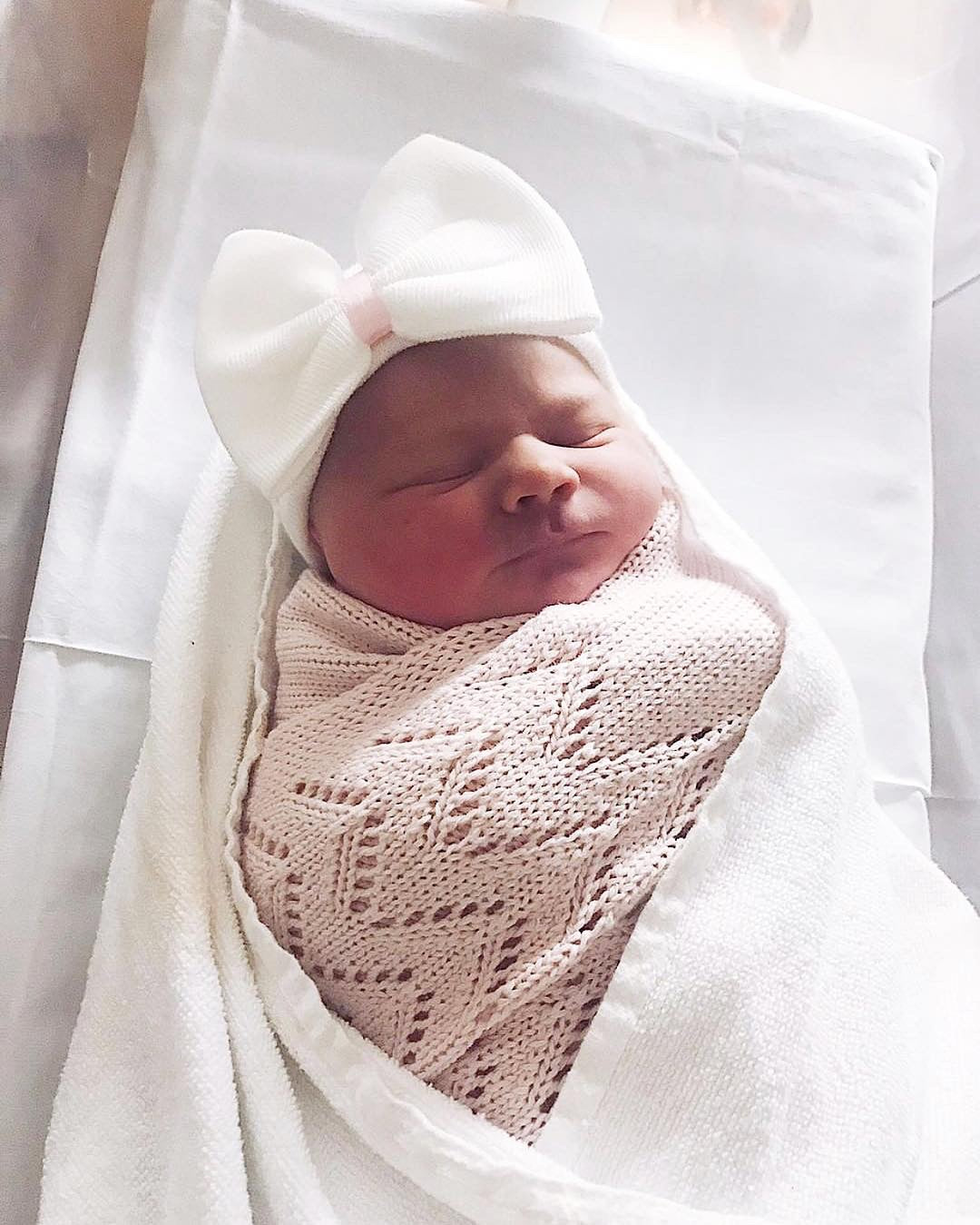 white baby hat with bow