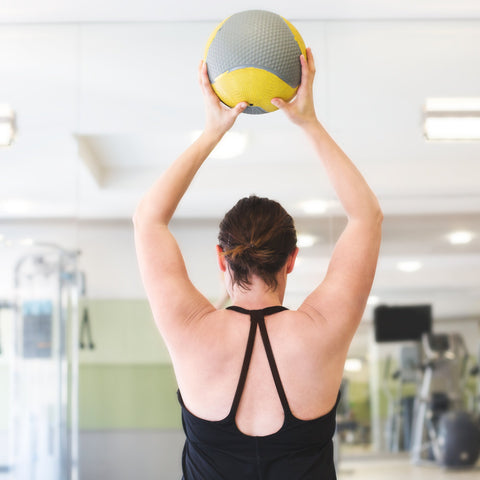Woman Lifting Exercise Fitness Ball For Weight Loss