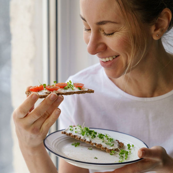 woman eating veggie toast
