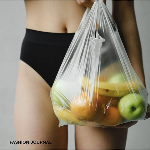 woman holding fruit bag