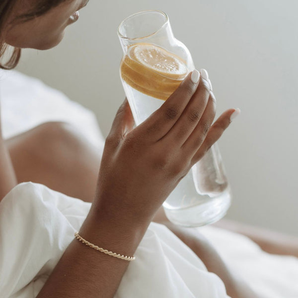 woman drinking lemon water