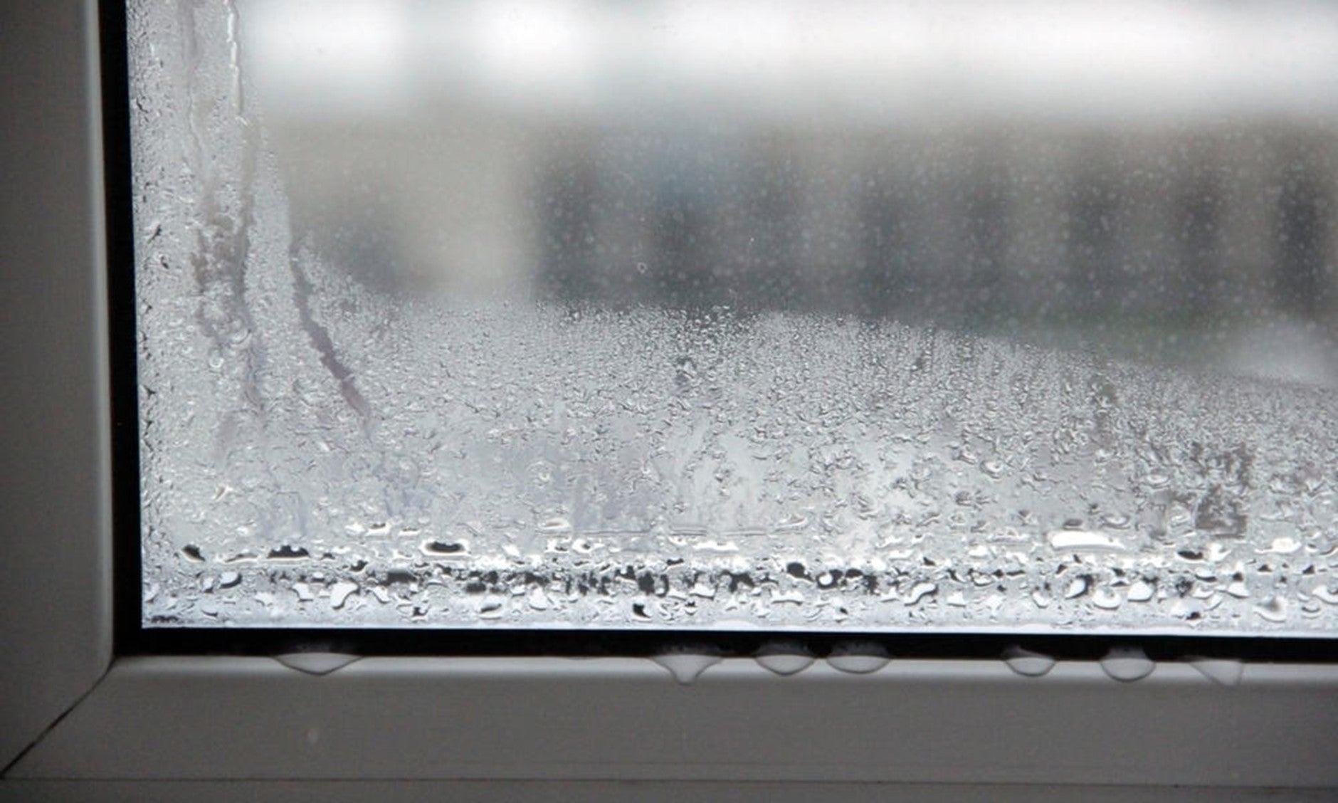 Image of a heavily condensated window with water dripping down