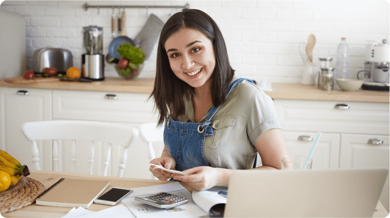 an image of a woman smiling calculating her bills