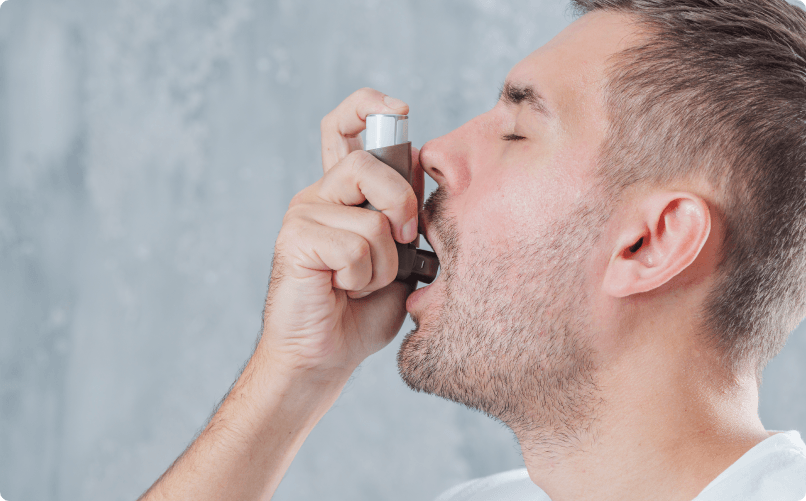 an image of a person, a man using his inhaler due to the air quality