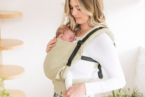 Sleeping newborn in a baby carrier