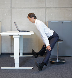 man exercising at standing desk