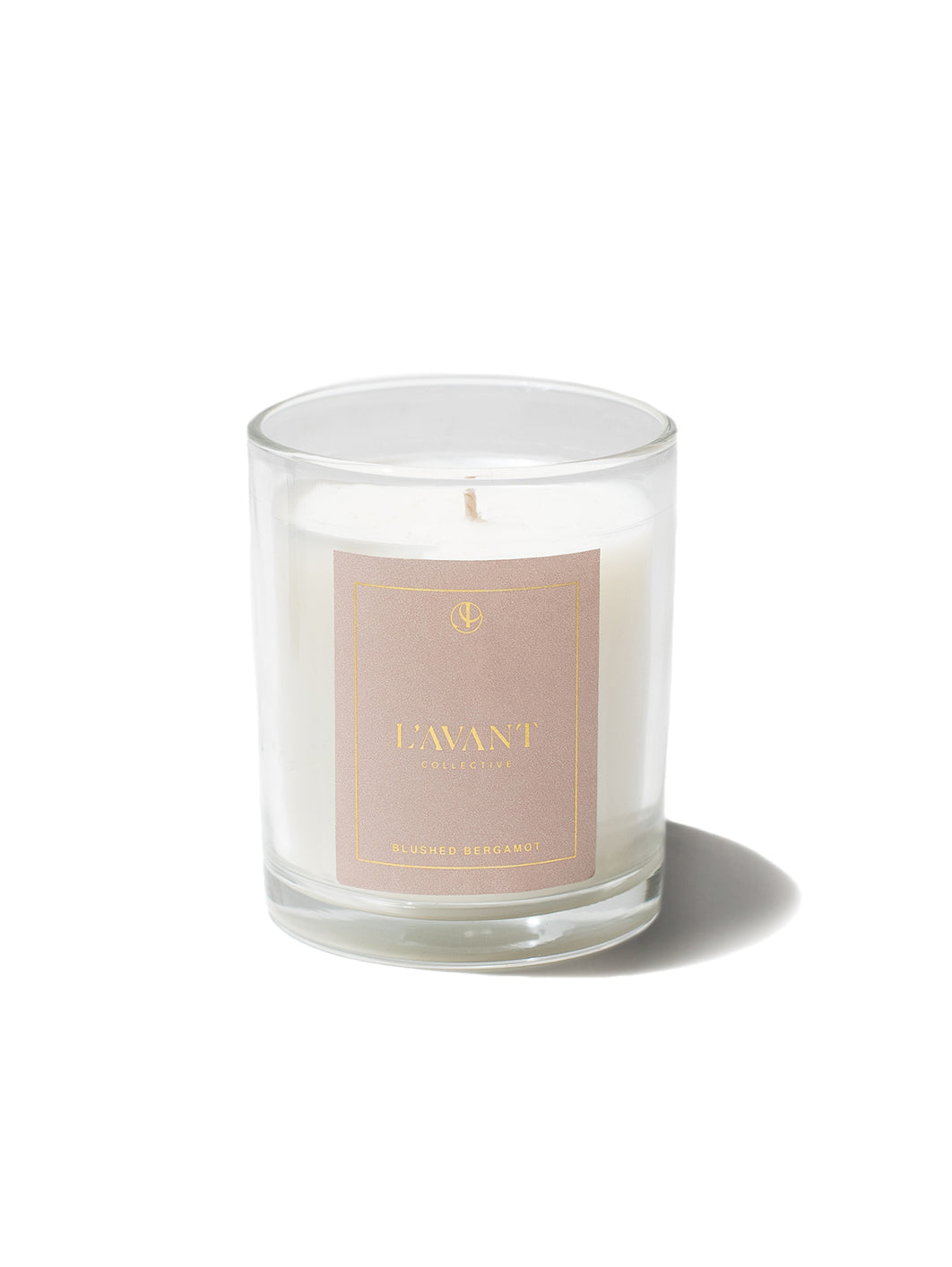 Clear White Candle with pink label and gold foil L'AVANT Collective label on front of label