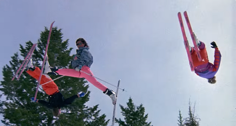 three people doing ski jumps at the same time
