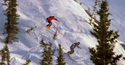 two skiiers race down a hill