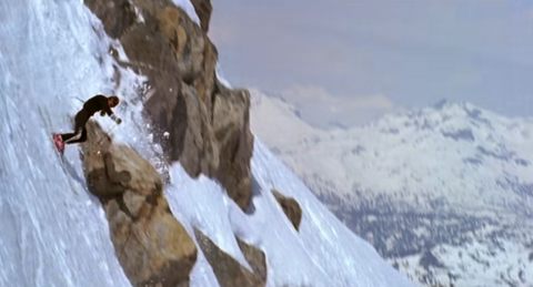 a skiier skis down a very steep slope