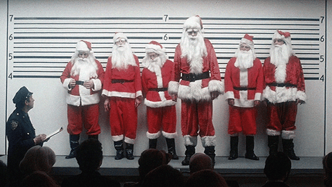 a police line-up of six men dressed in santa claus suits