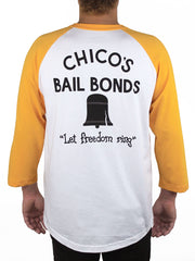 t-shirt with yellow sleeves and white body.  on the back it reads "chico's Bail Bonds, Let freedom ring" with a black bell