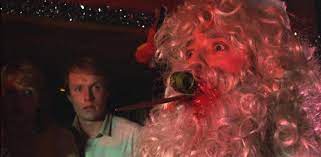 a man dressed as santa claus being stabbed in the face