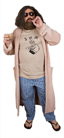 a man with long hair and a beard wears sunglasses, a bathrobe, pajama pants and holds a cigarette and a white russian cocktail