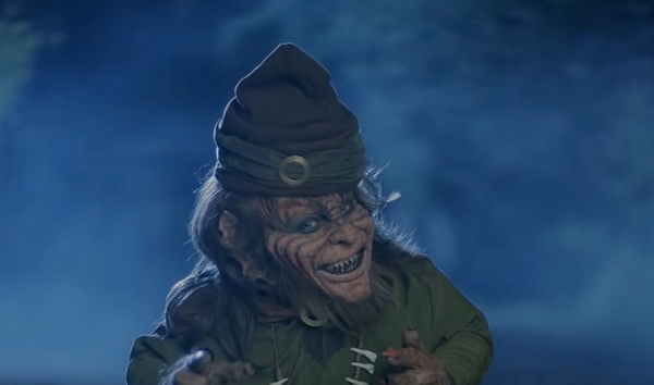 a scary leprechaun wears clothes from the middle ages