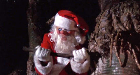 a man wearing a santa suit holding an axe