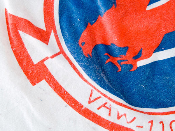 close up of white t-shirt with faded blue and red screen printing