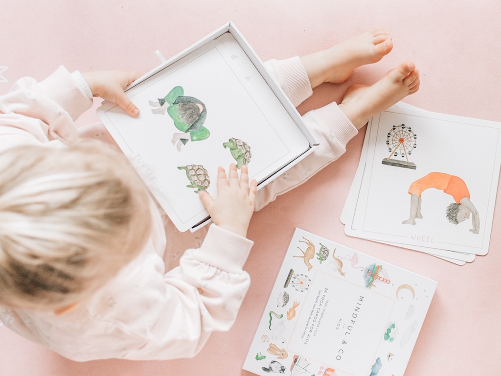 Kid sitting with Yoga Flash Cards