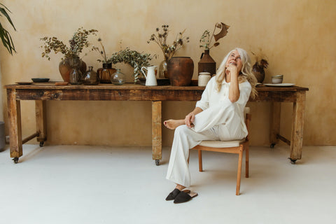 Woman sitting down by plants