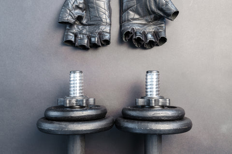 A pair of gloves and dumbbells