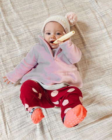 Baby Teething on a Baby Teether shaped as a Tube to promote chewing