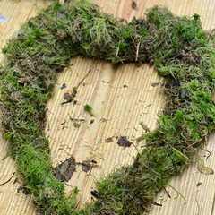 A heart shaped wreath covered in moss
