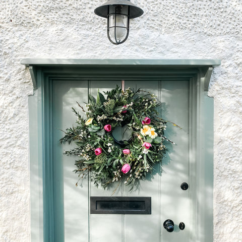 A Spring wreath full of tulips on the door of Rhubarb Cottage in time for Easter