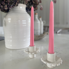 Handmade scalloped candle holder with pink candles on a kitchen worktop