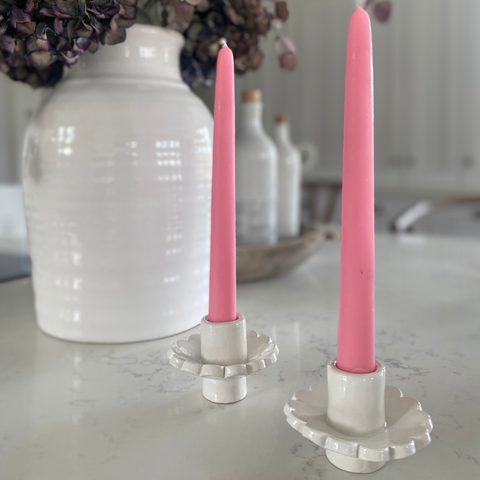 a pair of scalloped candle holders on a kitchen counter