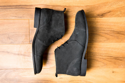 Black suede boots crafted using cemented construction method of shoe making