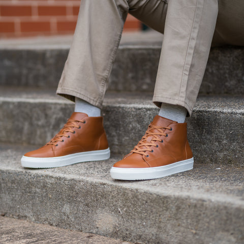High top sneakers for men paired with creme chinos