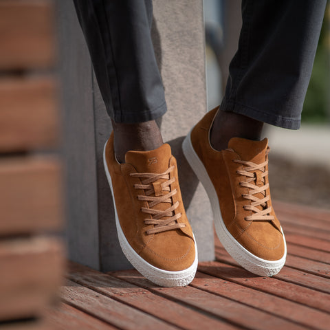 Suede sneakers paired nicely with green chinos