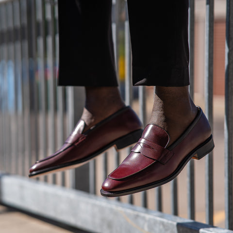 Mens slip on shoes in burgundy paired with dress pants