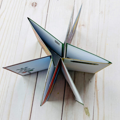 Accordion mini album shown standing upright on a table in a star shape