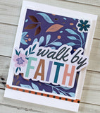handmade card on floral background with the die cut words, walk by faith. Card features a vibrant purple, gold, blue, and white color scheme.