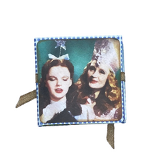 back panel of mini photo album showing Dorothy and Glinda the Good Witch of the North