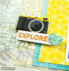 close up of puffy camera sticker layered on top of pretty turquoise and yellow scrapbook layout 