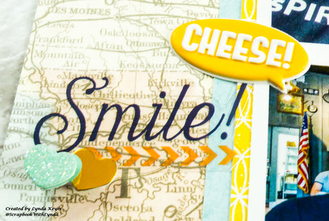 puffy sticker with the word Cheese in an oval call-out, and a clear Smile sticker incorporated into scrapbook layout