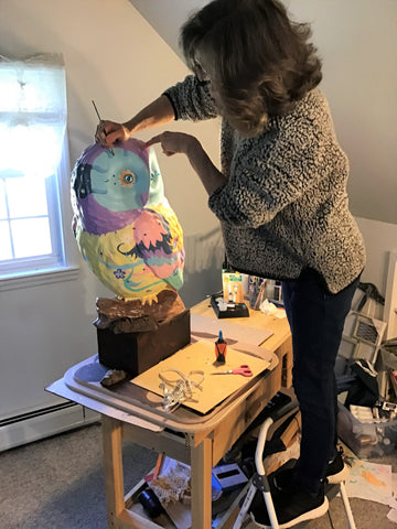 artist standing on step ladder while working on Fancy the owl