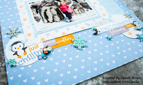 close up of bottom corner of penguin themed scrapbook page showing handmade embellishements
