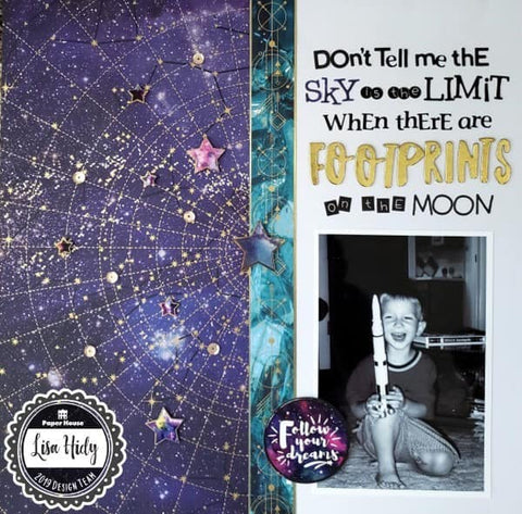 scrapbook page featuring boy holding a model rocket against a purple celestial / planetarium background