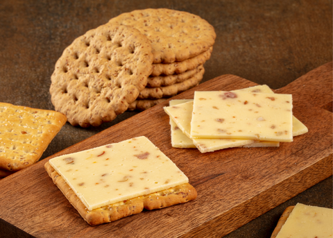 cheese and crackers on wooden board